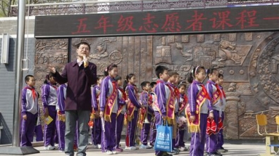 我校举行“志愿行动 有你有我”五年级升旗仪式